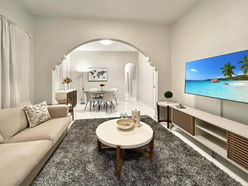a living room with a couch and a tv at Stunning 2-Bedroom Apartment in San Juan
