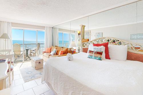 a bedroom with a bed and a view of the ocean at Islander W 304 in Fort Walton Beach