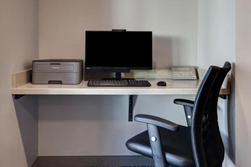 a computer sitting on a desk with a chair at TownePlace Suites by Marriott San Luis Obispo in San Luis Obispo