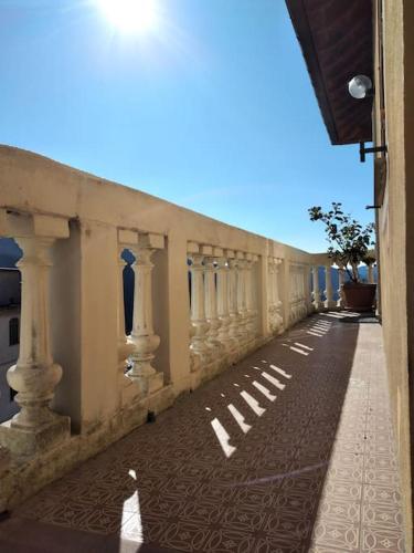 a building with a long hallway with white columns at CasarinoLaurino Among Cinque Terre Genova And Portofino in Uscio