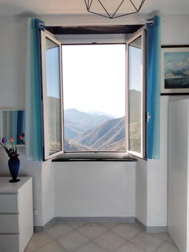 a room with a window with a view of a mountain at CasarinoLaurino Among Cinque Terre Genova And Portofino in Uscio
