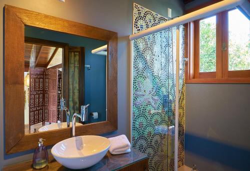 a bathroom with a sink and a shower at Casa Bali Ibira in Imbituba
