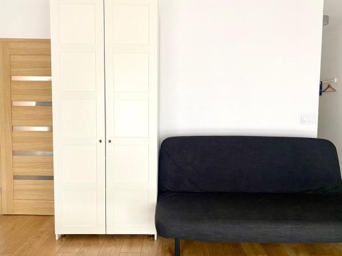 a bedroom with a bed and a white wall at K22 Komputerowa Warsaw Apartments in Warsaw