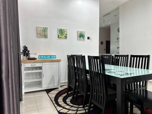 a dining room with a black table and chairs at Bandar Melaka Family Bungalow Private Pool BBQ WiFi Netflix in Melaka