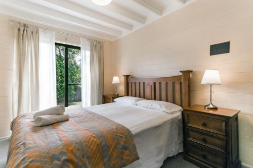 a bedroom with a large bed and a window at Arcadia in Wentworth Falls