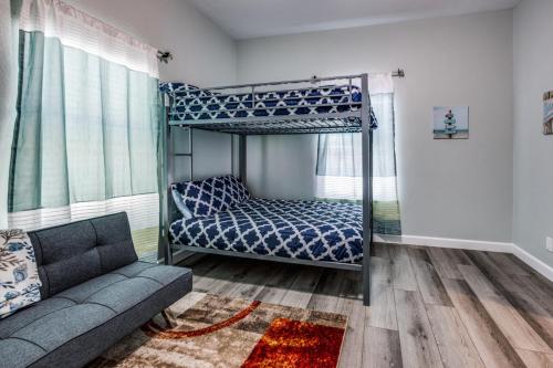 1 dormitorio con litera y sofá en Cozy brand new beach house - 2 mins to the beach en Galveston