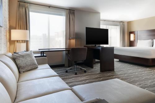 um quarto de hotel com um sofá, uma cama e uma secretária em Residence Inn by Marriott Anaheim Brea em Brea
