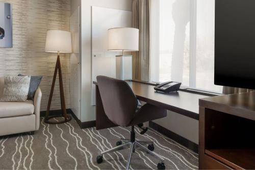 a hotel room with a desk and a chair at Residence Inn by Marriott Anaheim Brea in Brea