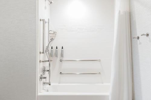 a white bathroom with a shower with a window at Residence Inn by Marriott Anaheim Brea in Brea