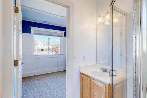 a bathroom with a sink and a mirror at Town of Rehoboth Beach 4 Maryland Ave in Rehoboth Beach