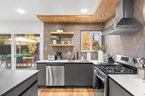 a kitchen with a sink and a stove top oven at #Marbella Lane - Modern 3BR Oasis in SiliconValley in San Jose