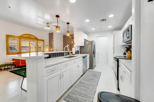 a kitchen with white cabinets and a large island at Sonoran Suite at St Phillips in Tucson