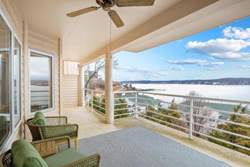 a room with a balcony with a view of the water at Emerald Bay Unit 1B in Lake Ozark