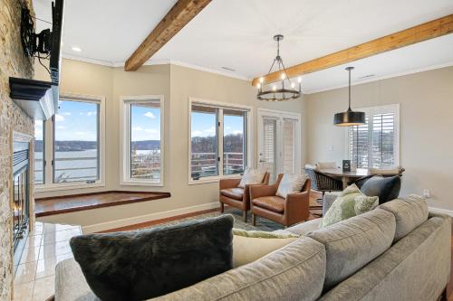 a living room with a couch and chairs and windows at Emerald Bay Unit 1B in Lake Ozark