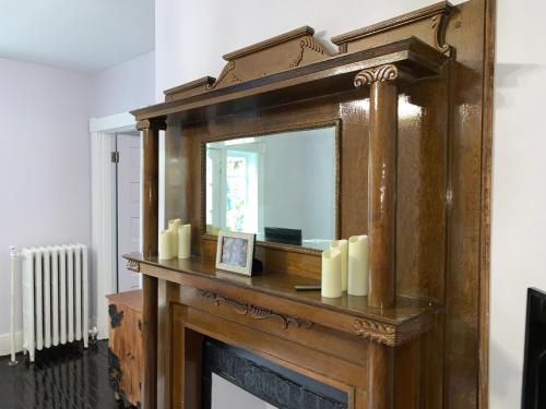 a mirror on top of a fireplace with candles at Historical District 2BDRM built in 1910 in Lynchburg