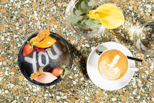 a table with a plate of food and a cup of coffee at Le Méridien Vienna in Vienna