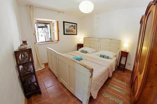 a bedroom with a large bed in a room at Secluded fisherman's cottage Cove Vela Studena, Brac - 20904 in Selca