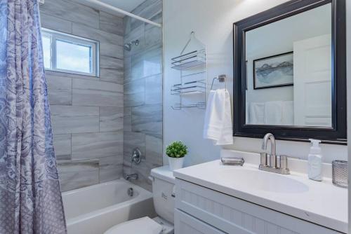 a bathroom with a sink and a tub and a toilet at Secret Garden in San Antonio