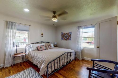 a bedroom with a bed and a ceiling fan at Charming! King bed, W/D, A/C, Garage in Twin Falls