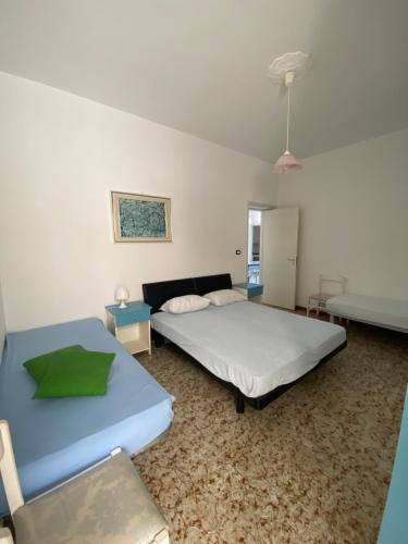 a bedroom with two beds and a couch at Baia camerini in Villanova di Ostuni