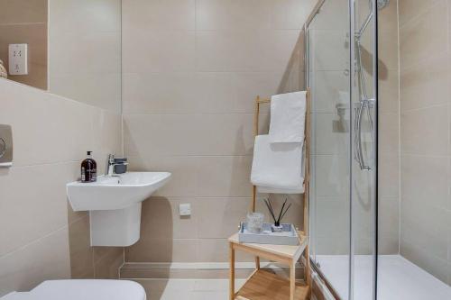 a white bathroom with a sink and a shower at BR2 - Stunning 1 Bed Apartment Heart of Borough in London