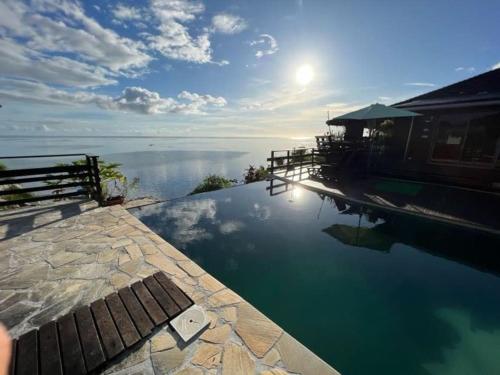 a swimming pool with a view of the water at Tehuarupe Surf Studio 2 in Haapiti