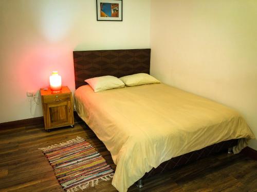 a bedroom with a bed with a candle on a night stand at Killa Wasi B&B in Chachapoyas