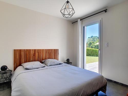 a bedroom with a large bed and a large window at Maison Crozon, 4 pièces, 6 personnes - FR-1-370-37 in Crozon