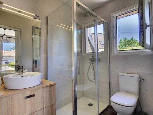 a bathroom with a toilet and a sink and a shower at Maison Crozon, 4 pièces, 6 personnes - FR-1-370-37 in Crozon
