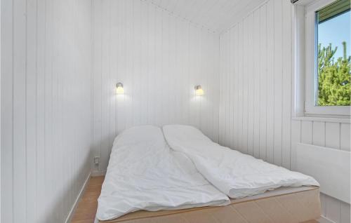 a bed in a white room with a window at Stunning Home In Hemmet With Kitchen in Hemmet