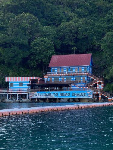 a welcome to nongo chirico building next to the water at Perhentian Nemo Chalet in Perhentian Island