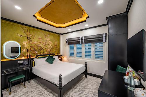 a bedroom with a bed and a desk and a mirror at White Lotus Boutique Hotel, Ho Chi Minh in Ho Chi Minh City