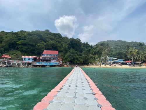 a pathway in the water in front of a beach at Perhentian Nemo Chalet in Perhentian Island