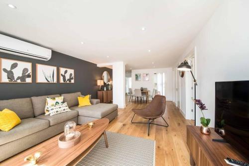 a living room with a couch and a table at 7 Borough Apartments - Spacious 2-Bed, 2-Bath in Prime Location in London
