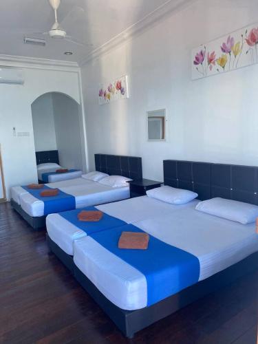 a group of four beds in a room at Perhentian Nemo Chalet in Perhentian Island