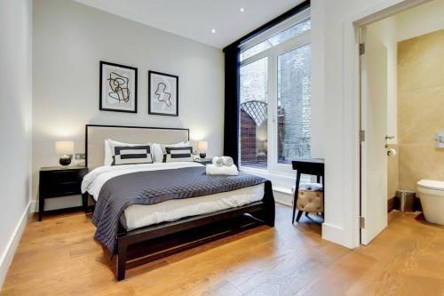 a bedroom with a large bed and a large window at Number 8 Borough Apartments 2 Bed 2 Bath in London