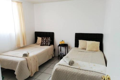 サカテカスにあるEn el Centro Histórico, Casa de los Abuelos.のベッド2台が隣同士に設置された部屋です。