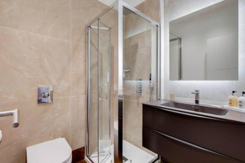 a bathroom with a shower and a sink and a toilet at Number 10 Borough Apartments 2 Bed 2 Bath in London
