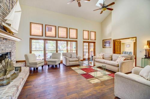 a living room filled with furniture and a fireplace at Spacious Merritt Island Home Private Pool and Dock! in Merritt Island