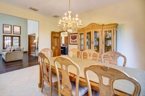 a dining room with a wooden table and chairs at Spacious Merritt Island Home Private Pool and Dock! in Merritt Island