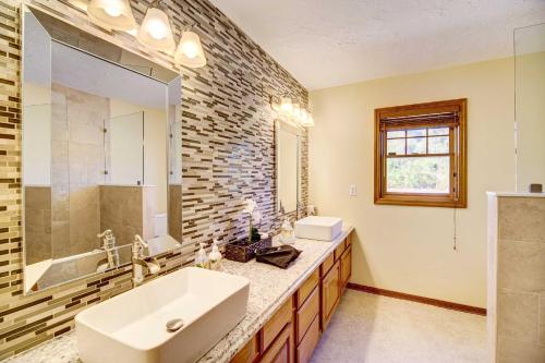 a bathroom with a sink and a mirror at Florida Vacation Rental with Private Pool and Dock! in Merritt Island