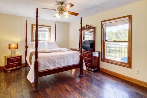 a bedroom with a bed and a television in it at Florida Vacation Rental with Private Pool and Dock! in Merritt Island