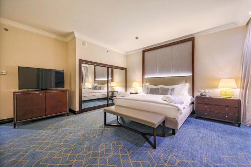 a hotel room with two beds and a flat screen tv at InterContinental Warszawa by IHG in Warsaw