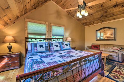 a bedroom with a bed and a couch in a room at Bryson City Cabin Rental with Mountain View, Hot Tub in Bryson City