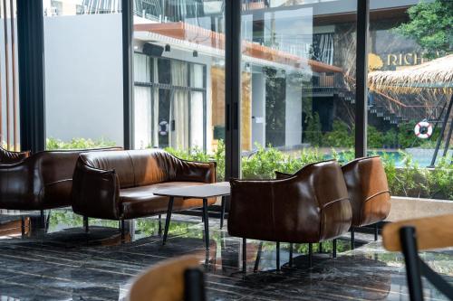 a row of leather chairs and tables in a building at Richmann Resort Hotel Hatyai in Hat Yai