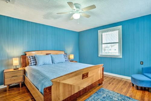 a blue bedroom with a bed and a ceiling fan at Family Vacation Rental 18 Mi to Philadelphia in Gibbstown