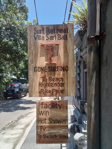 a sign on the side of a building at Surf Retreat Villa Sari Bali in Pulukan