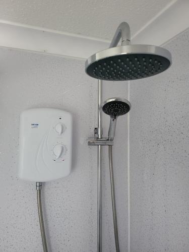 a shower head and a light in a bathroom at The Bobbers in Great Yarmouth