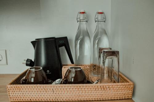 庫塔的住宿－Truntum Boutique Mandalika，一个装有两瓶玻璃瓶和搅拌器的篮子