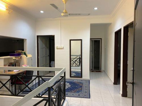 a living room with a ceiling fan and a mirror at AlFarizqi Muslim Residence SP in Sungai Petani